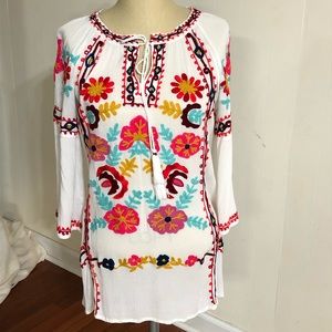 Long white shirt with beautiful floral embroidery.